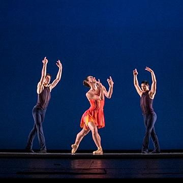 三个现代舞演员摆出手臂向上伸展的姿势.